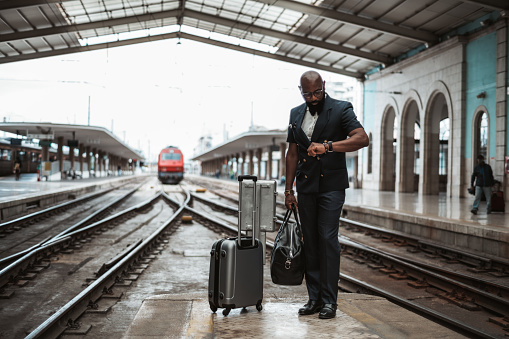A businessman on a railroad platform