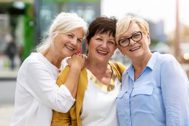 Photo of Three senior female friends having good time together