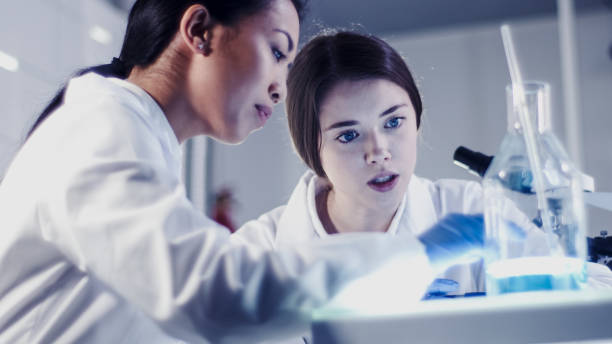 istock Female team working in futuristic laboratory. Discussing 1256339328
