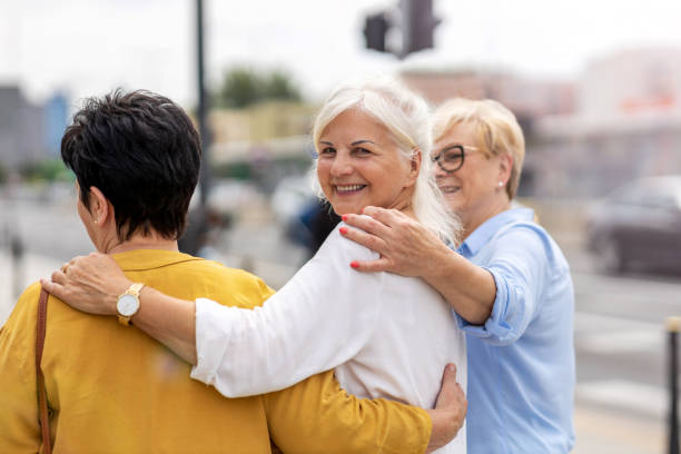 Three senior female friends having good time together