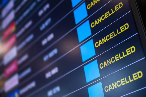 Airport lockdown, Flights cancellation on time table Airport lockdown, Flights canceled on information time table board in the airport while coronavirus outbreak pandemic issued around the world commercial airplane stock pictures, royalty-free photos & images