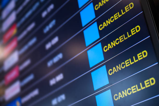 Airport lockdown, Flights cancellation on time table Airport lockdown, Flights canceled on information time table board in the airport while coronavirus outbreak pandemic issued around the world cancellation stock pictures, royalty-free photos & images