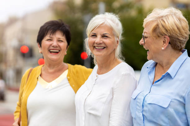 Three senior female friends having good time together