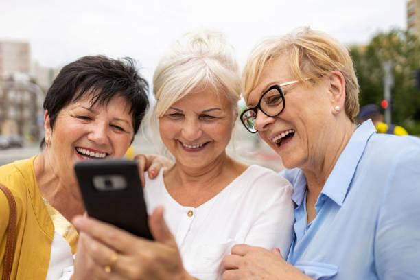 istock Group of senior women using mobile phone together 1256339992