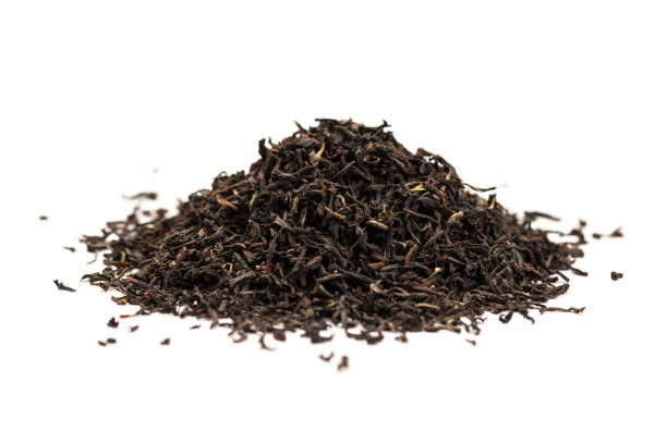 istock Fragrant Leaves of black premium dry tea on a white background 1256341364