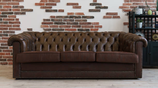 istock Brown leather couch in Loft style room and brick wall in background 1256341554