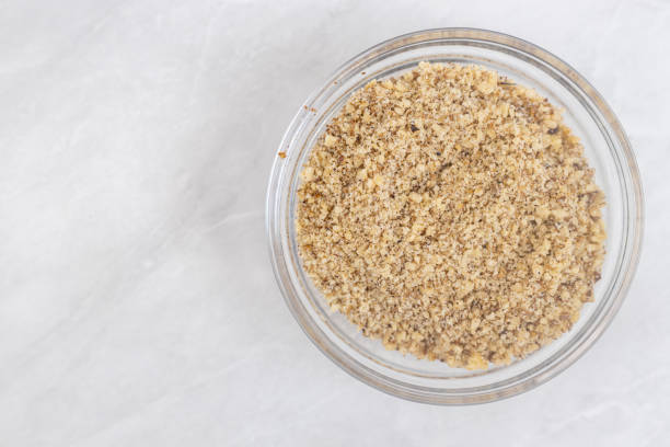 Grated almonds in the bowl on the table. stock photo