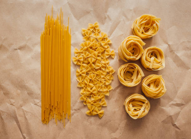 istock Spaghetti, farfalle and tagliatelle isolated on a white background. 1256344136