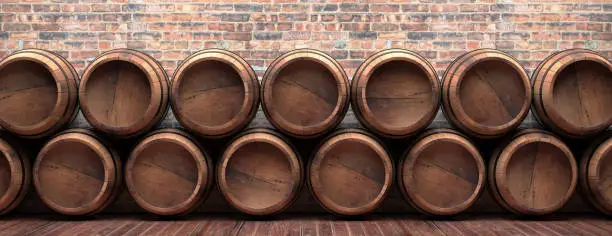 Winemaking, wine storage concept. Old barrels stacked on wooden floor, vintage brickwall background, banner. Beer, alcohol, whiskey cellar. 3d illustration