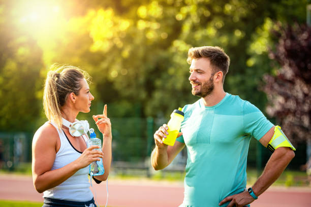 istock Couple taking a break after workout at the park 1256346553