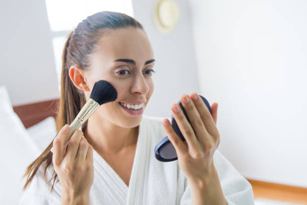 istock Woman at home applying makeup while getting ready in the morning 1256347080