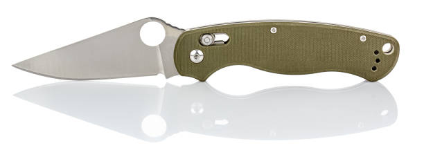 istock Side view of open folding pocket knife with matte blade and green composite plastic cover plates on steel handle isolated on white background with reflection on glossy surface. Pocket knife close-up 1256348098