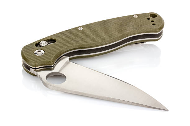 istock Lying open folding pocket knife with matte blade and dark green composite plastic cover plates on steel handle isolated on white background with reflection on glossy surface. Pocket knife close-up 1256348101