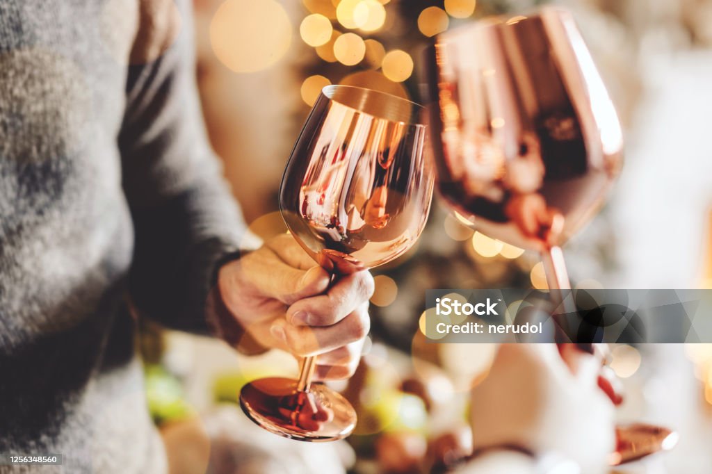 People clink glasses and celebrating Closeup of people clink glasses. Christmas or New Year. Celebrating and toasting. Celebratory Toast Stock Photo