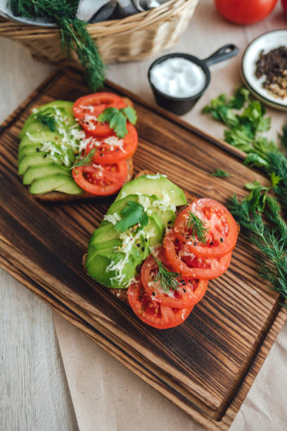 Healthy vegan homemade sandwich with avocado and tomatoes.