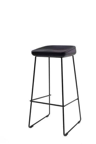 istock Steel frame high bar stool with a black seat. Loft style interior 1256350562