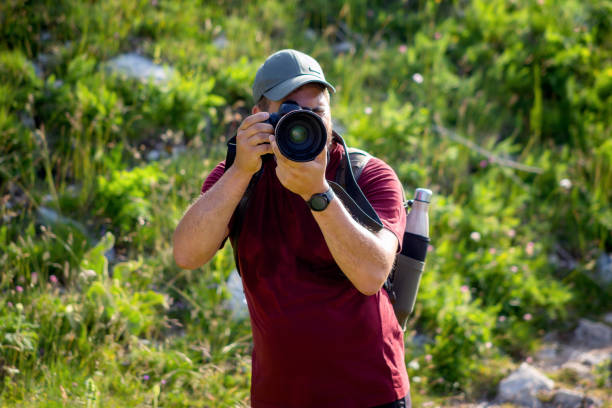 istock Nature photographer explores a mountain path. 1256351157