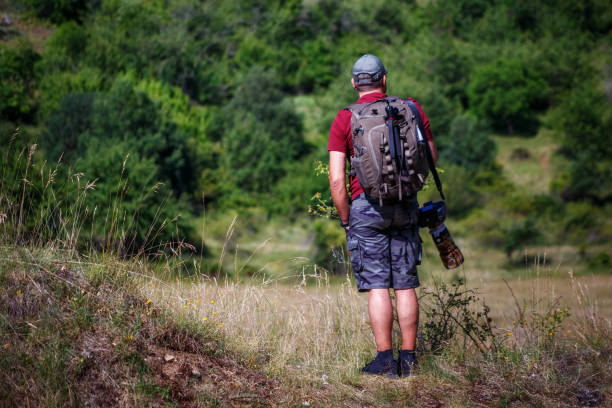 istock Nature photographer explores a mountain path. 1256351158