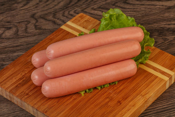 istock Tasty meat sausages over board 1256352478