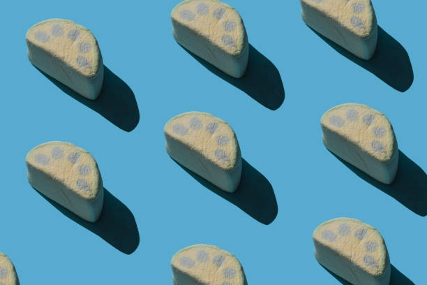 istock Pattern of tasty marshmallows with hard shadows on a blue background. 1256353420