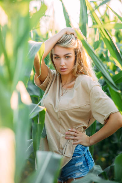 istock Sexy woman walks among cornfield. 1256353434