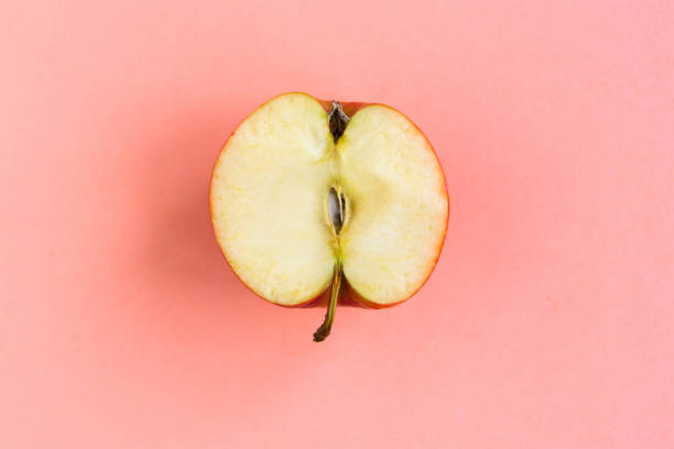 istock Sliced red apple on pastel pink background, minimal concept 1256354862