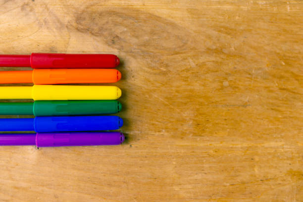 istock Color pencils on wooden background, top view, copy space for the text 1256354942