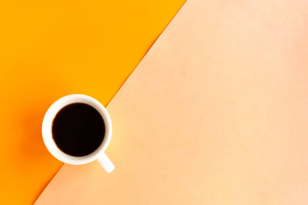 istock Coffee cup on geometric orange background, top view, copy space for the text, minimal concept 1256355012