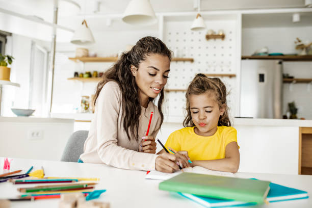 istock Mother and daughter doing homework together 1256356115