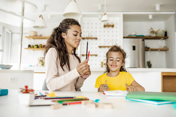 istock Mother and daughter doing homework together 1256356172