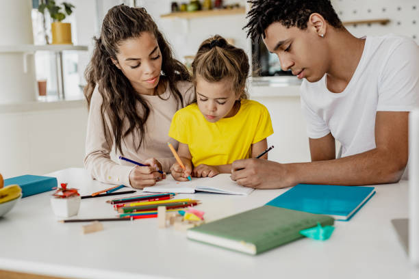 istock Young parents homeschooling their child 1256356230