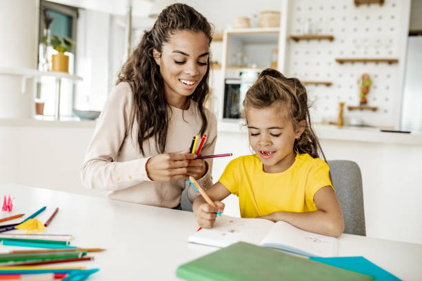 istock Mother and daughter doing homework together 1256356232
