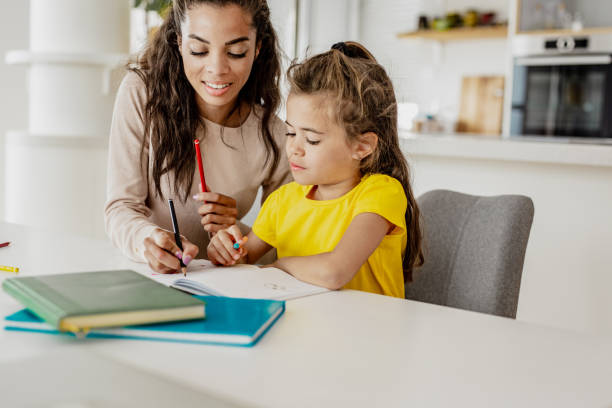 istock Mother and daughter doing homework together 1256356251