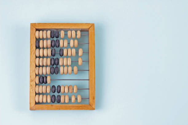 Old wooden abacus close up on blue background. Copy space for text