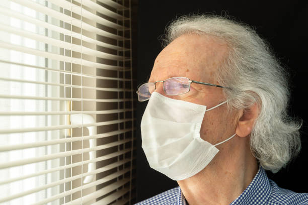 istock Senior Man Wearing Surgical Mask 1256360118