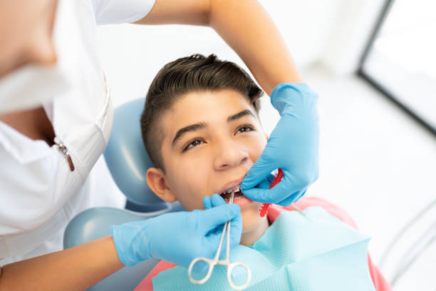 istock Boy Visiting Dentist For Treatment 1256361555