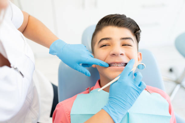 istock Orthodontist Checking Teeth Of Patient 1256361587