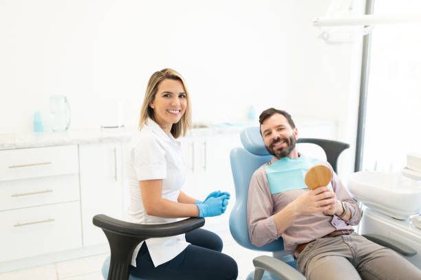 istock Smiling Dentist With Patient In Clinic 1256361628