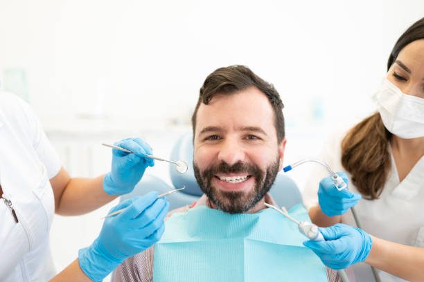 istock Smiling Man At Dental Clinic 1256361660
