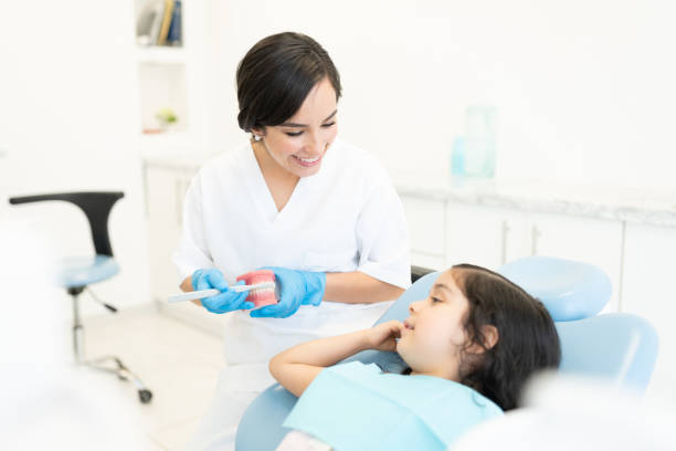 istock Dentist Showing how to brush teeth 1256361893