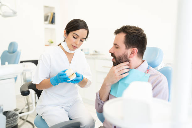 istock Man Discussing With Orthodontist During Checkup 1256362667
