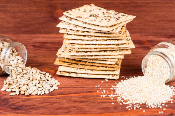 istock Healthy snack: cereal crunchy multigrain cereal flax seed, sesame, sunflower seeds protein bread bar and sunflower and sesame seeds in a jar. Protein albumin source. vegetarian food, eco food concepts 1256362855