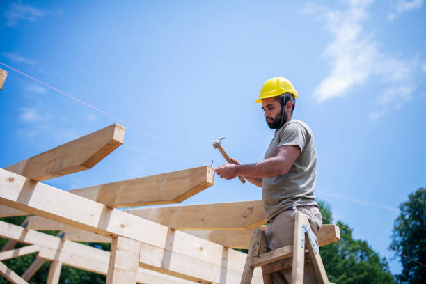 istock Construction Workers Working On Wooden Roof Of House. 1256366113