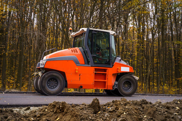 istock Road roller flattening new asphalt. Heavy vibration roller at work paving asphalt, road repairing. Selective focus. 1256366463