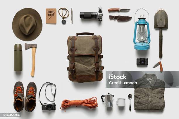 Packing Backpack For A Trip Concept With Traveler Items Isolated On White Background Stock Photo - Download Image Now