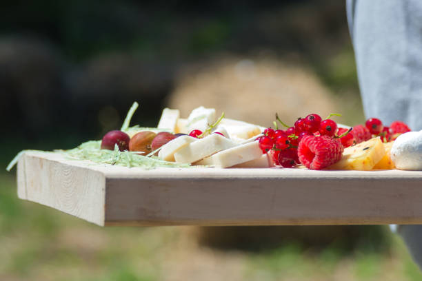 istock Raspberry berries among organic goat cheese in a craft cheese factory. 1256368231