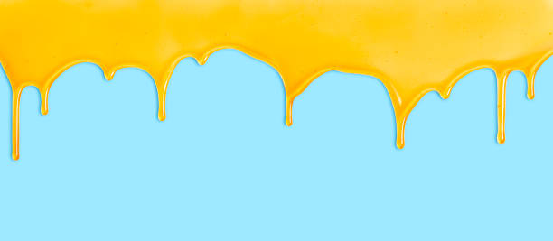 istock Honey dripping on blue background. Natural bee honey drip. Liquid dripping 1256368495
