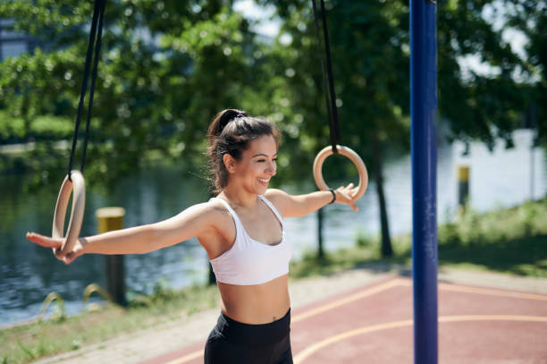 istock Female athlete is smiling on gymnastic rings 1256369714