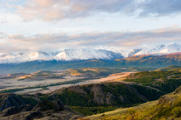 beautiful sunrise, an amazing view of the Altai mountains covered with snow, the autumn steppe, the Chuya river. stock photo