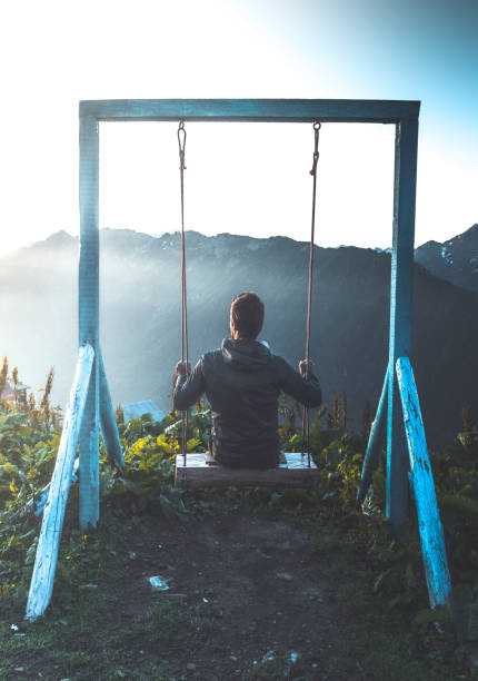 istock Young man swing to freedom in Kackar mountains, Turkey 1256371043